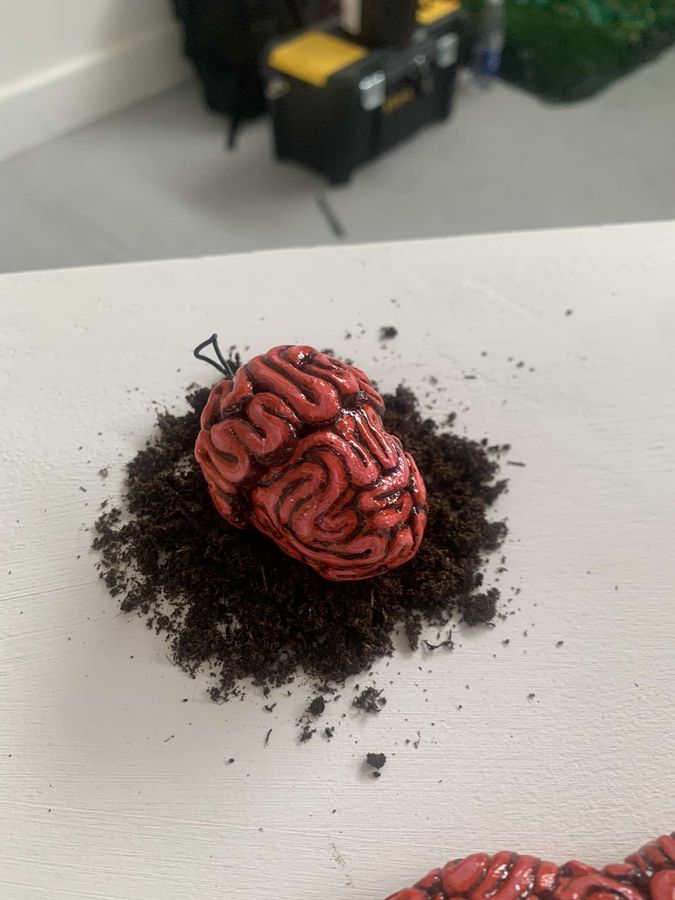 ‘Due Today: Eco-consciousness’, clay sculpture among ivy